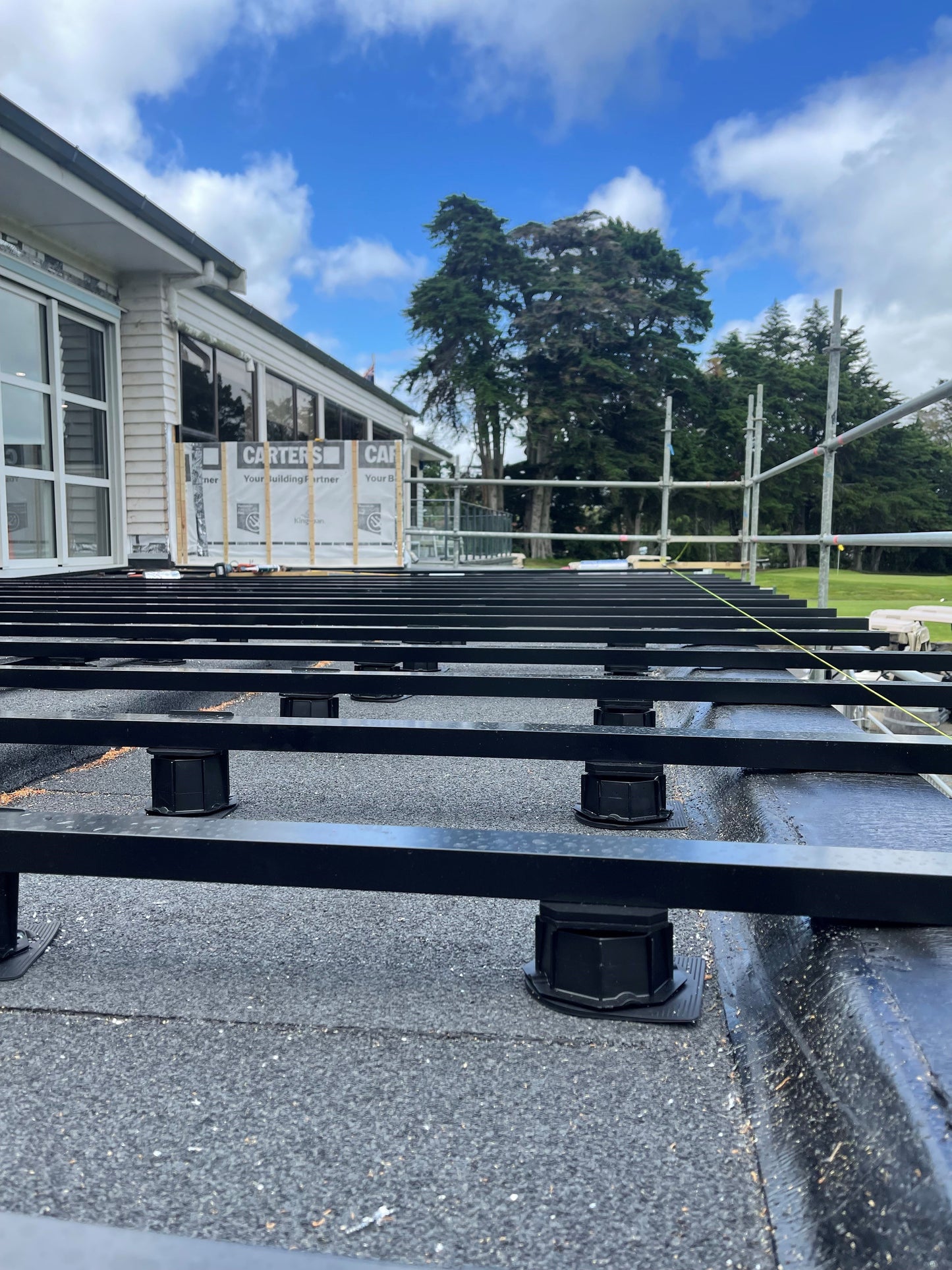 Aluminium Framed pedestal deck Pukekohe Golf Club Auckland with composite decking installed by Pukekohe builders. Aluframe New Zealand's number one timber and composite subframe.
