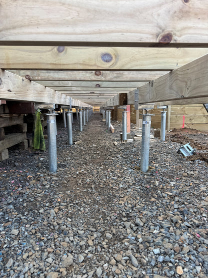 Ground screws installed to hold up a portable classroom for a school